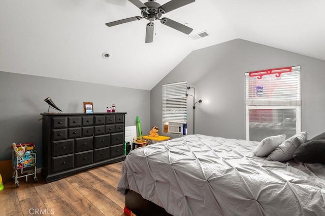 bedroom with ceiling fan, wood-type flooring, and vaulted ceiling