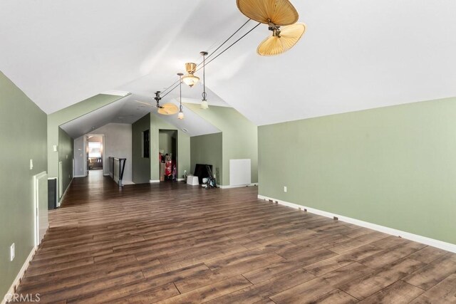 additional living space with dark hardwood / wood-style flooring and vaulted ceiling