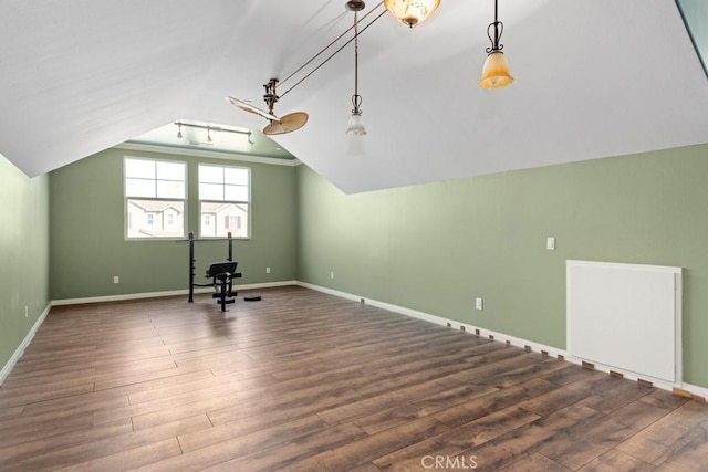 additional living space featuring lofted ceiling and dark hardwood / wood-style flooring