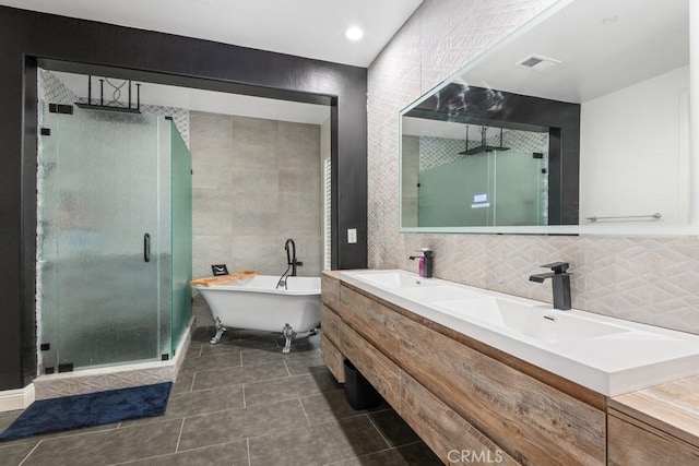 bathroom with shower with separate bathtub, tile walls, vanity, tile patterned flooring, and backsplash