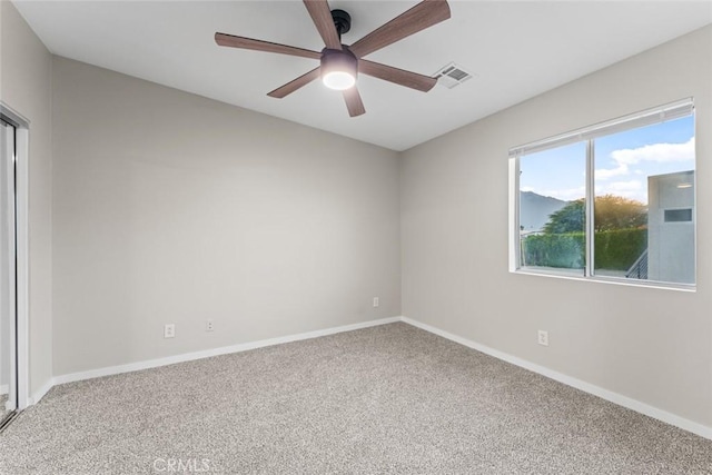 carpeted empty room featuring ceiling fan