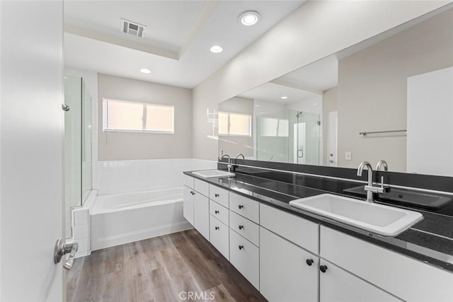 bathroom featuring vanity, shower with separate bathtub, and hardwood / wood-style floors