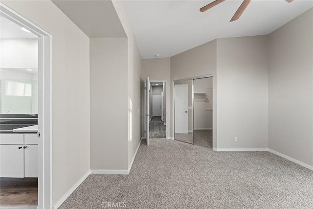 unfurnished bedroom with ensuite bathroom, light carpet, ceiling fan, and a closet