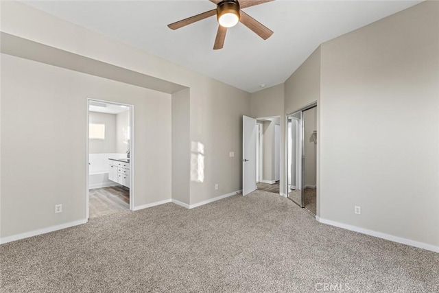 unfurnished bedroom featuring ensuite bath and light carpet