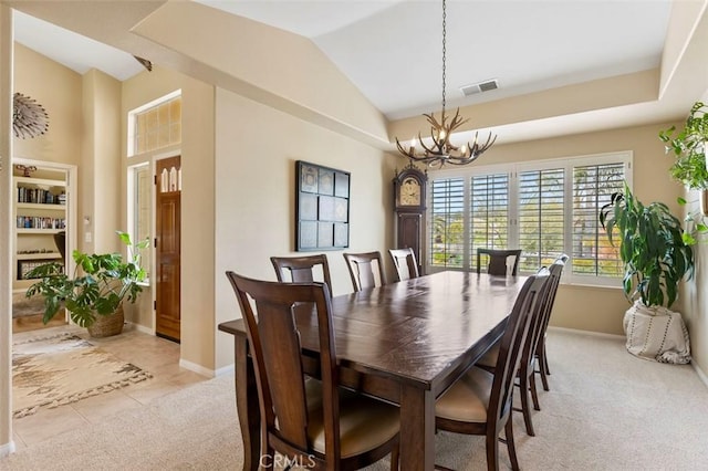 carpeted dining space with an inviting chandelier and vaulted ceiling