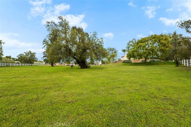 view of yard with a rural view