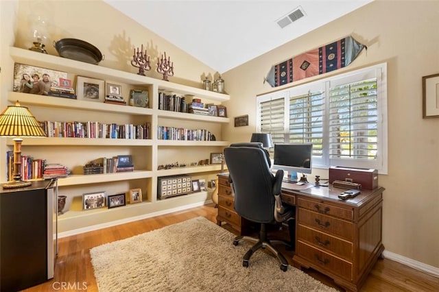 office space with lofted ceiling and hardwood / wood-style floors