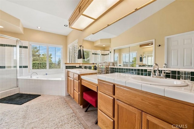 bathroom featuring tile patterned flooring, a healthy amount of sunlight, and separate shower and tub