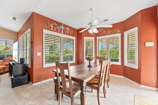 dining room with light tile patterned flooring, ceiling fan, and vaulted ceiling