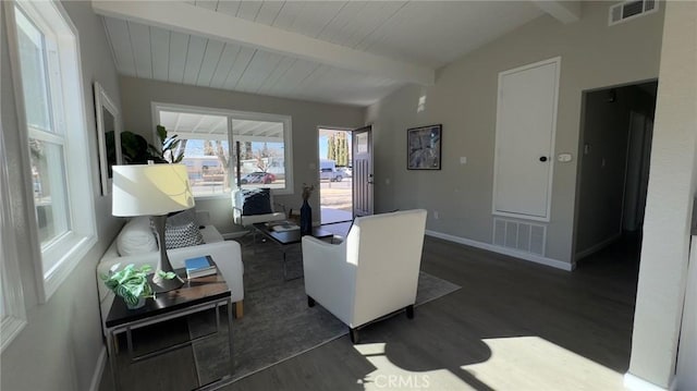 living room featuring dark hardwood / wood-style floors and vaulted ceiling with beams