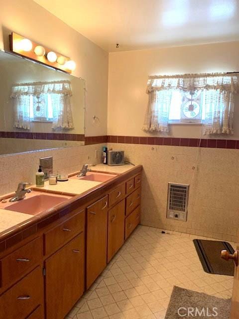 14650 Pearl Ave, Clearlake, CA 95422 - full bath featuring tile walls, heating unit, a wainscoted wall, and double vanity