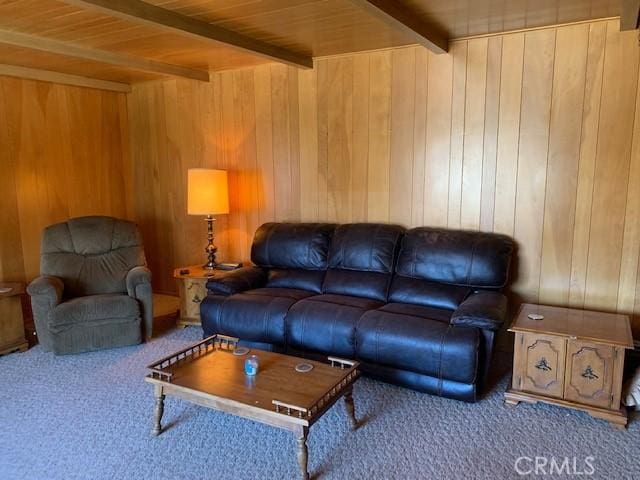 living room with wood ceiling, wooden walls, beamed ceiling, and carpet flooring