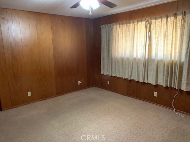 14650 Pearl Ave, Clearlake, CA 95422 - spare room featuring a ceiling fan, carpet flooring, and wooden walls