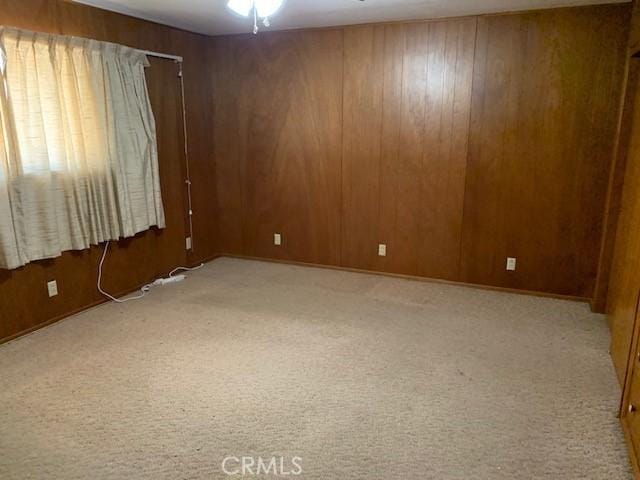 14650 Pearl Ave, Clearlake, CA 95422 - spare room with carpet floors, wood walls, and a ceiling fan