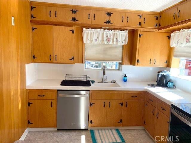 14650 Pearl Ave, Clearlake, CA 95422 - kitchen featuring plenty of natural light, stainless steel dishwasher, and light countertops