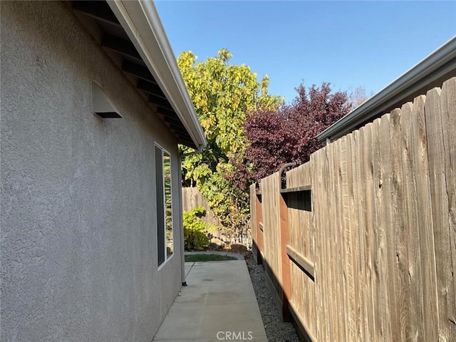 view of side of property with a patio area