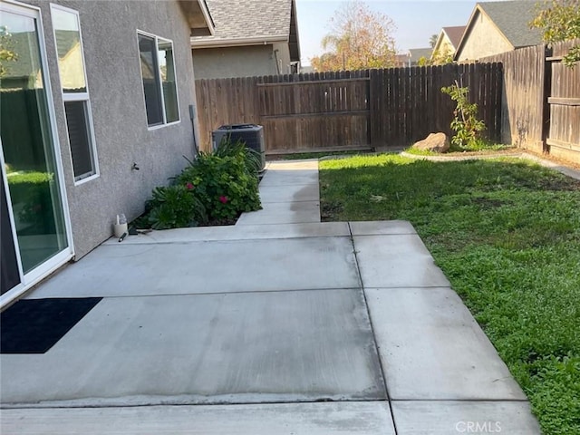 view of yard featuring a patio and central air condition unit