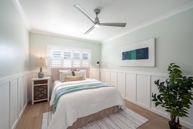 bedroom featuring crown molding, ceiling fan, and light wood-type flooring