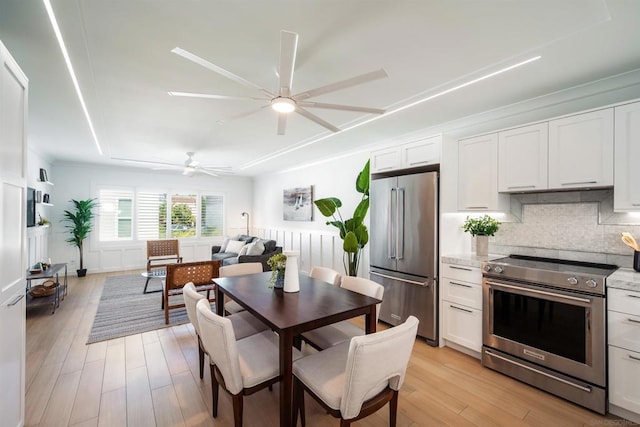 dining space featuring ceiling fan and light hardwood / wood-style floors