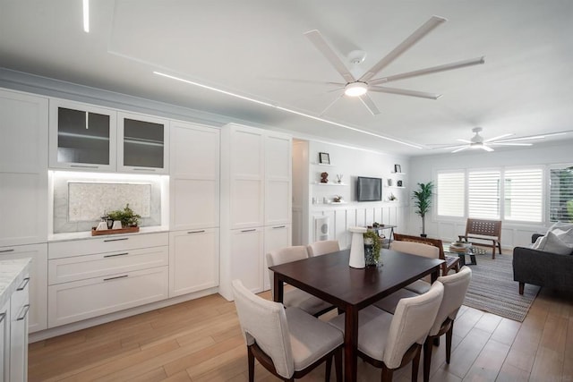 dining area with ceiling fan and light hardwood / wood-style flooring