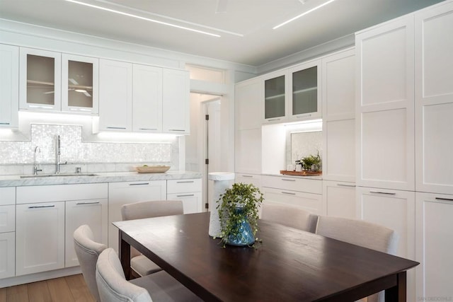 dining area with sink and hardwood / wood-style floors