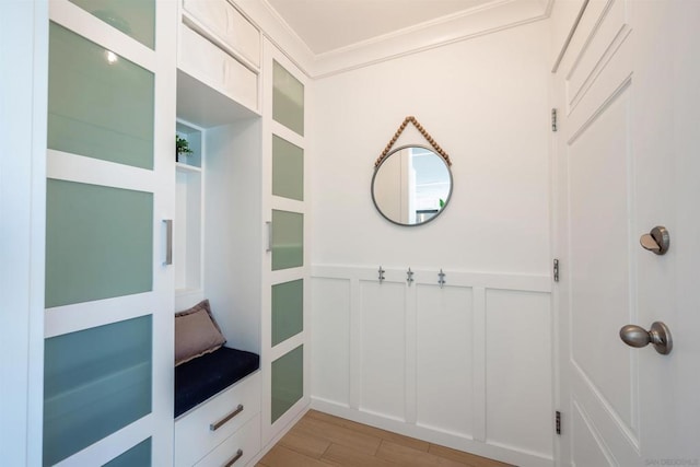 mudroom featuring crown molding and light hardwood / wood-style flooring