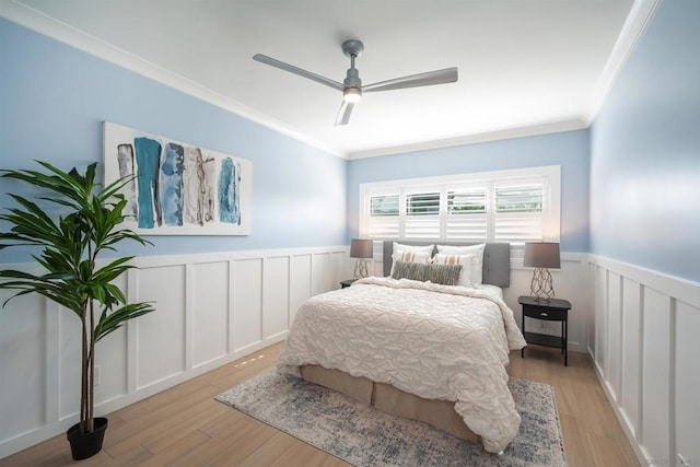 bedroom featuring ornamental molding, ceiling fan, and light hardwood / wood-style flooring