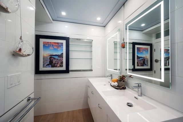 bathroom with vanity, wood-type flooring, and tile walls