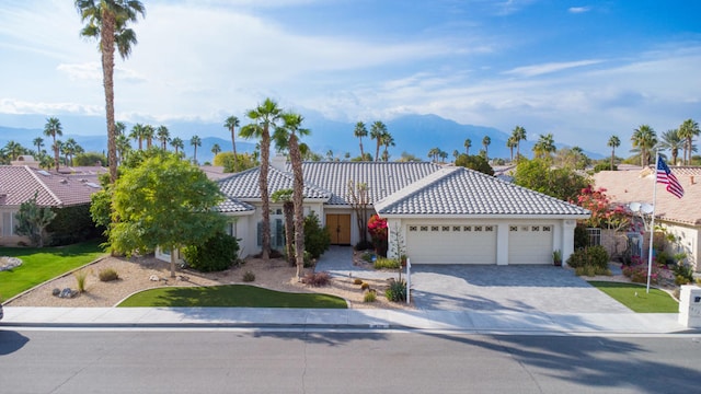 view of front of home featuring a garage and a mountain view