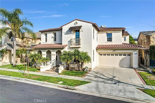 mediterranean / spanish home with a garage