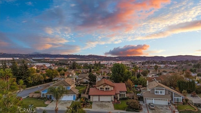 aerial view at dusk featuring a mountain view