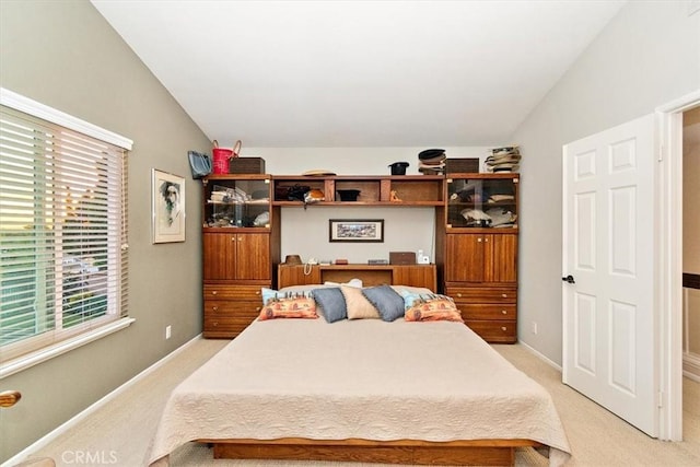 carpeted bedroom featuring vaulted ceiling