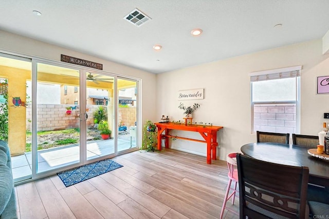 doorway with a wealth of natural light and light hardwood / wood-style flooring