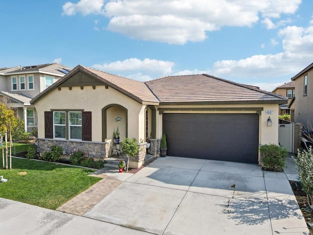 view of front of home featuring a garage and a front lawn