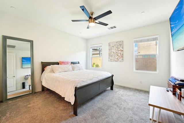 carpeted bedroom featuring multiple windows and ceiling fan