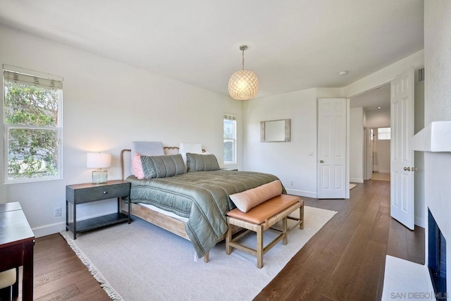 bedroom with wood-type flooring and multiple windows