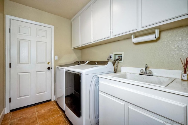 laundry room with independent washer and dryer, cabinets, tile patterned floors, and sink