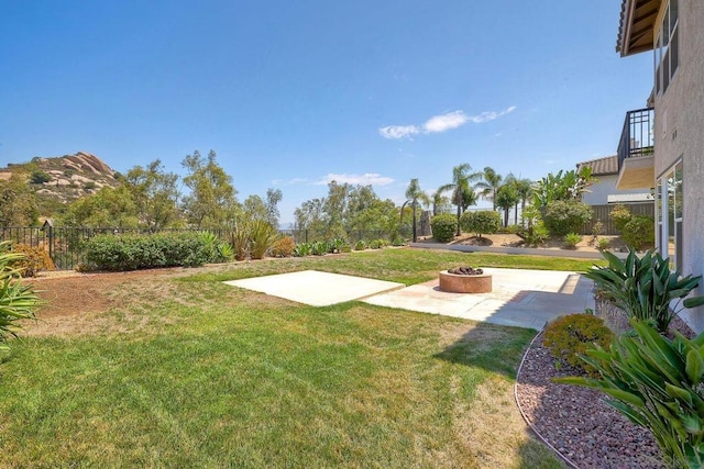 view of yard featuring a patio, a mountain view, and a fire pit