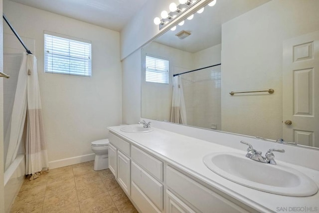 full bathroom featuring tile patterned flooring, vanity, shower / tub combo with curtain, and toilet