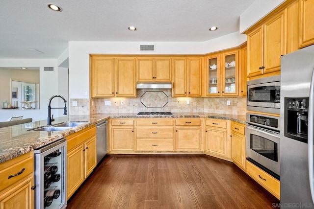 kitchen with wine cooler, dark wood-type flooring, sink, light stone counters, and stainless steel appliances