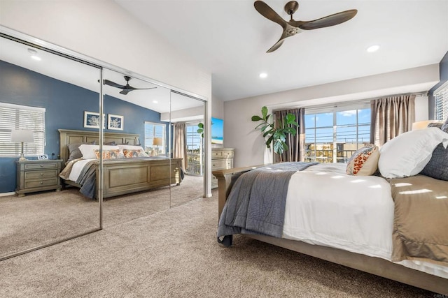 carpeted bedroom with ceiling fan and a closet