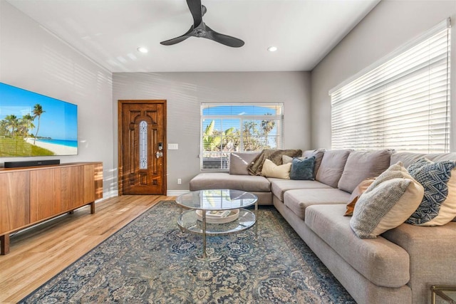 living room with hardwood / wood-style floors and ceiling fan