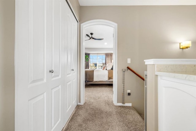 hallway with light colored carpet