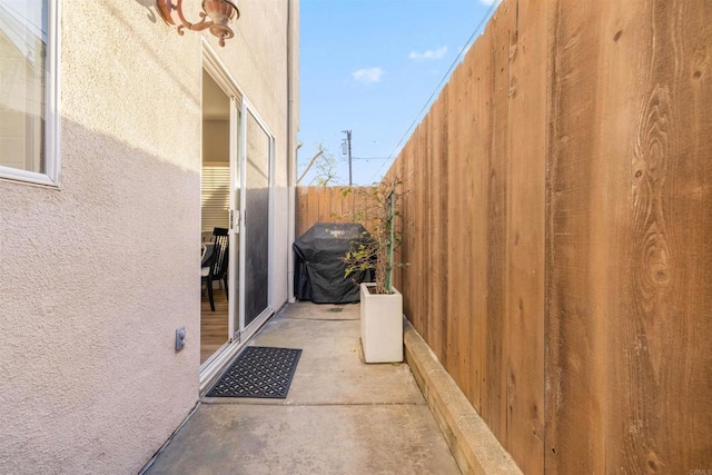 view of property exterior with a patio area