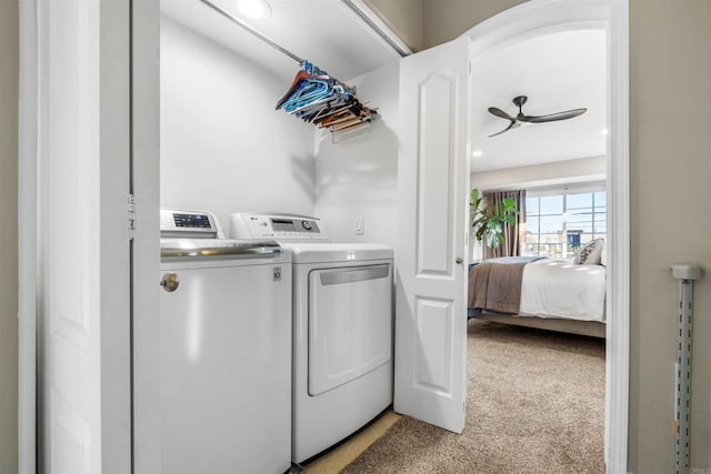 washroom featuring ceiling fan, washer and clothes dryer, and light carpet