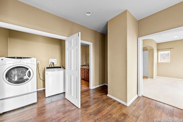 laundry area with hardwood / wood-style flooring and separate washer and dryer