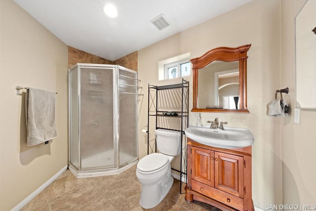 bathroom featuring vanity, toilet, and a shower with door