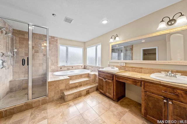 bathroom with vanity and independent shower and bath