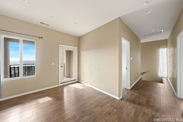 empty room with hardwood / wood-style flooring