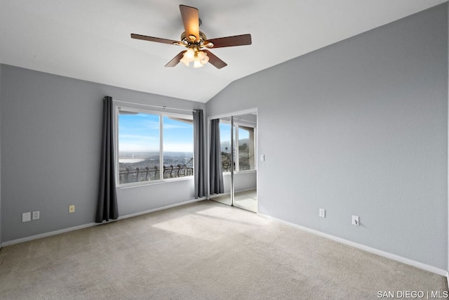 spare room with light carpet, lofted ceiling, and ceiling fan